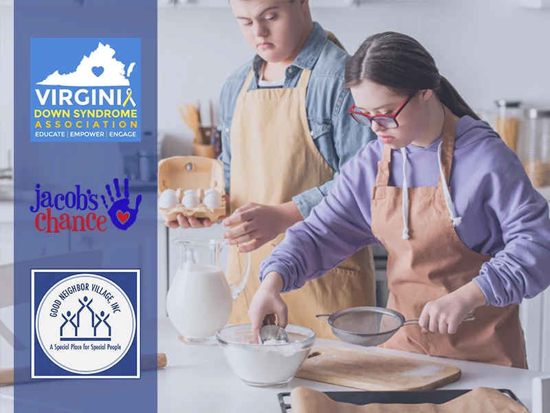 Two residents in aprons cooking in a kitchen with the VDSA, Jacob's Chance, and Good Neighbor Village logos to the left.